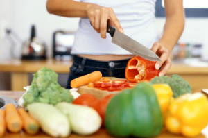 A woman preparing and chopping vegetables A woman preparing and chopping vegetables