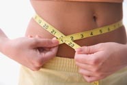 A woman measuring her waist
