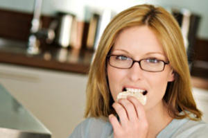 A woman eating at work A woman eating at work