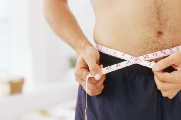 A man measuring his waist