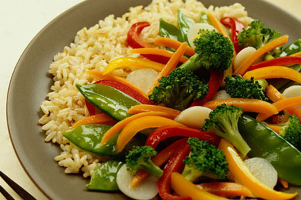 A plate of brown rice and stir-fry vegetables
