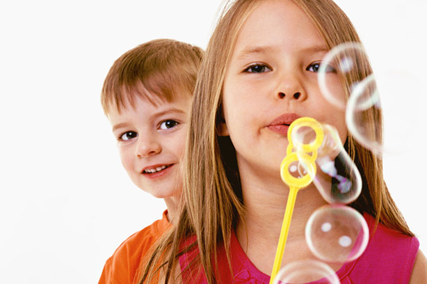 A young girl blowing bubbles