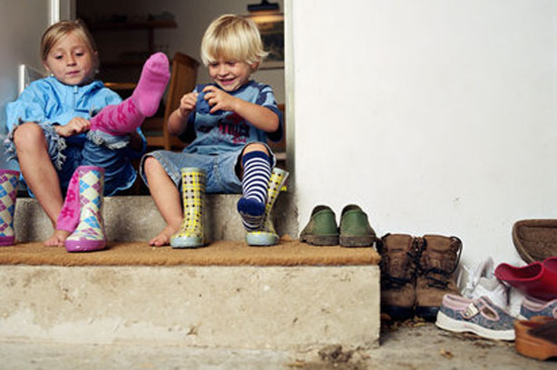 Independant child toddler putting on shoes