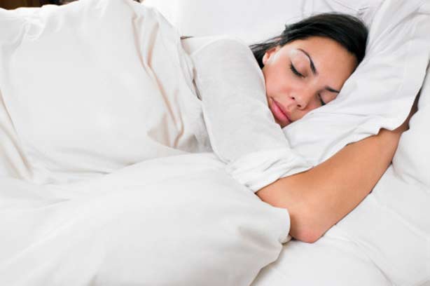 A woman asleep in her bed