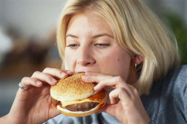 A woman eating a burger A woman eating a burger