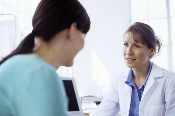 A woman talking to a female doctor A woman talking to a female doctor