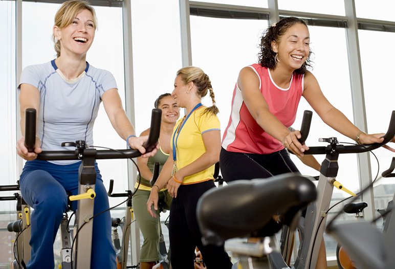 Women-on-exercise-bikes-taking-part-in-a-spin-class