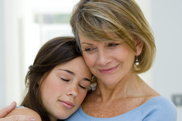 Mum hugging her daughter reassuringly