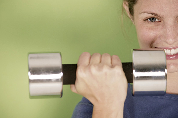 Woman holding weights indoors