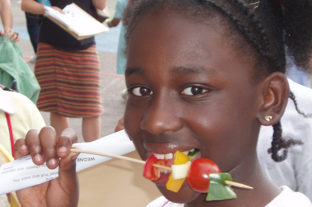 Girl eating vegetable kebab_school dinners campaign Girl eating vegetable kebab_school dinners campaign