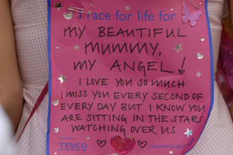 Sign pinned to a woman's back with a message for her mum