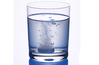 A tablet dissolving in a glass of water