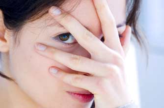 Woman covering her face with her hands