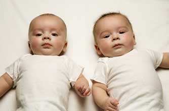 baby twins on a bed_rex