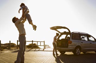 Dad and children in car by beach_rex