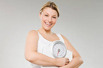 Woman holding scales_Photolibrary Woman holding scales_Photolibrary