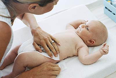 Baby being changed on a mat Baby being changed on a mat