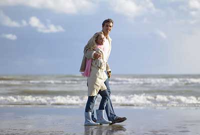 Couple walking on a beach Couple walking on a beach