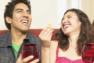 Couple laughing with drink Couple laughing with drink