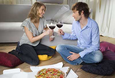 Couple eating pizza and drinking wine Couple eating pizza and drinking wine