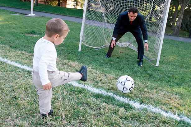 A boy practising kicking a ball