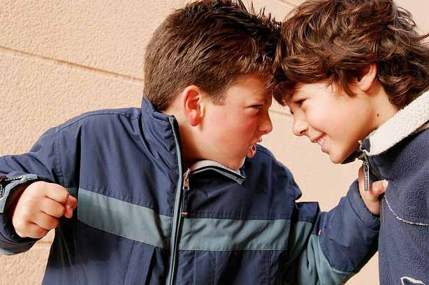 A boy bullying another