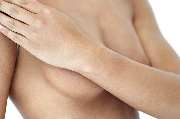 A woman covering her breasts