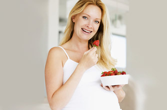 Pregnant woman eating strawberries Pregnant woman eating strawberries