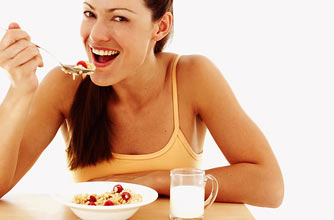 Woman eating breakfast_Photolibrary