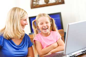 mum and daughter laughing at something online_istock
