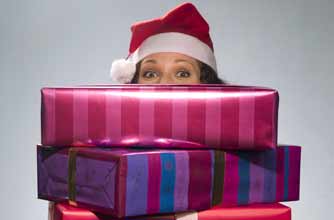 Woman holding a pile of Christmas gifts_rex