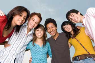 teenagers in a huddle smiling_istock