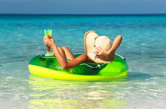 Woman with cocktail in tropical sea