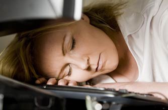 A woman asleep at a computer A woman asleep at a computer