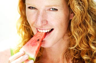 Woman eating melon, watermelon