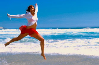 Woman jumping on the beach