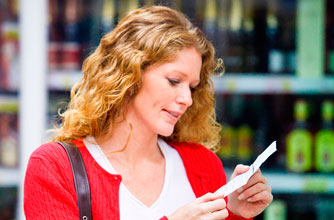 Looking at her shopping list Looking at her shopping list