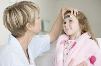 A girl having her temperature taken