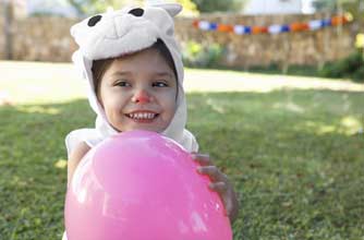 Girl dressed as a rabbit playing with a balloon