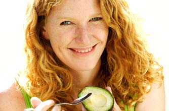Woman eating avocado