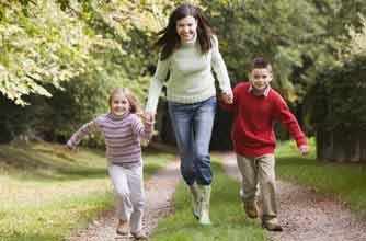 A mum running with her daughter and son