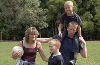 Family playing football in the park Family playing football in the park