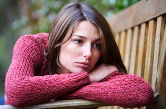Depressed woman sitting on a bench