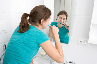 woman brushing her teeth woman brushing her teeth