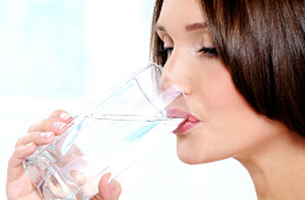 woman drinking a glass of water woman drinking a glass of water