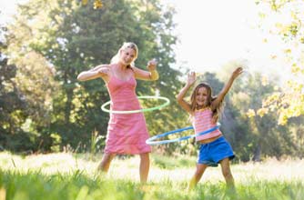 mother and daughter playing hula hoop mother and daughter playing hula hoop