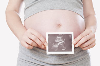 Nub theory: Woman holding up a scan picture