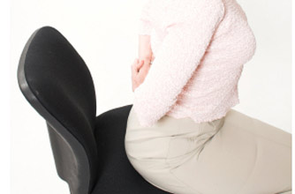 Woman sitting on an office chair Woman sitting on an office chair