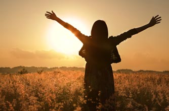 Woman happy in the sunset
