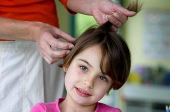 Girl having her hair inspected for head lice